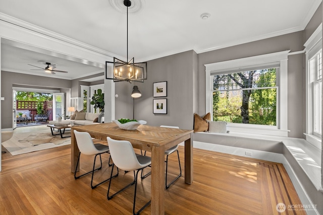 2159 10th Ave W, Seattle, WA 98119 - dining room featuring ornamental molding, wood finished floors, a chandelier, and a ceiling fan