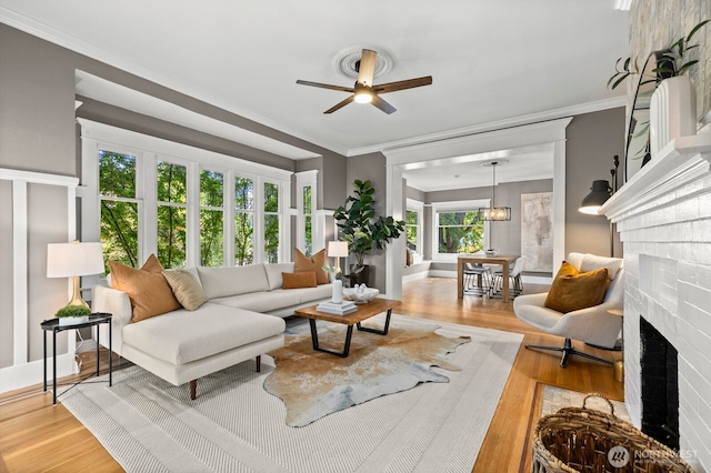 2159 10th Ave W, Seattle, WA 98119 - living area with a fireplace, a ceiling fan, wood finished floors, and crown molding