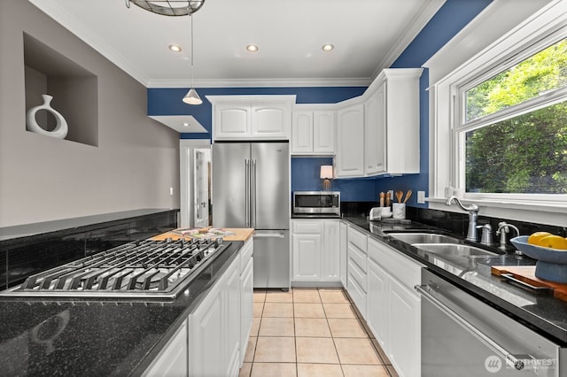 2159 10th Ave W, Seattle, WA 98119 - kitchen with stainless steel appliances, white cabinets, light tile patterned floors, ornamental molding, and dark stone countertops