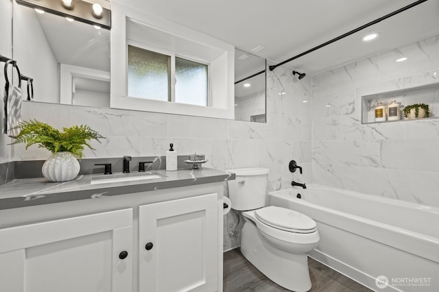 2159 10th Ave W, Seattle, WA 98119 - full bath with vanity, washtub / shower combination, wood finished floors, and tile walls