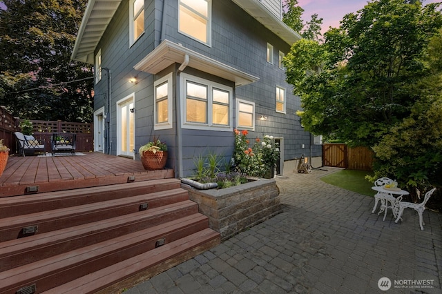 2159 10th Ave W, Seattle, WA 98119 - back of property at dusk with a wooden deck and a patio