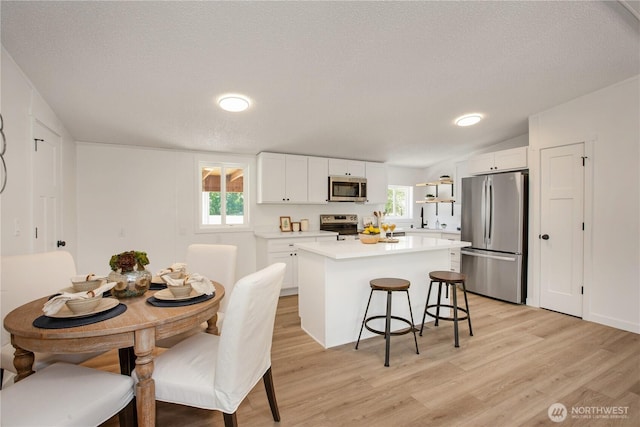 36715 Allen Rd S, Roy, WA 98580 - dining room with light wood finished floors, a textured ceiling, and lofted ceiling