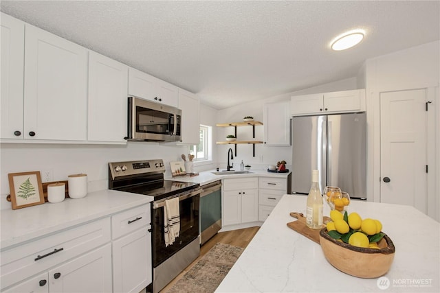 36715 Allen Rd S, Roy, WA 98580 - kitchen with appliances with stainless steel finishes, open shelves, light wood finished floors, white cabinetry, and a textured ceiling
