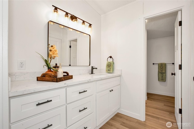 36715 Allen Rd S, Roy, WA 98580 - bathroom featuring double vanity, wood finished floors, and ornamental molding