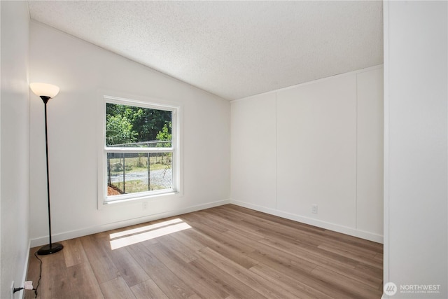 36715 Allen Rd S, Roy, WA 98580 - empty room with a textured ceiling, light wood finished floors, and vaulted ceiling