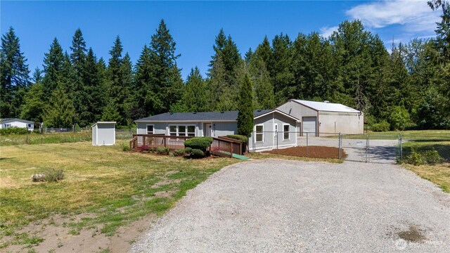 36715 Allen Rd S, Roy, WA 98580 - single story home featuring gravel driveway, a gate, an outbuilding, and a deck