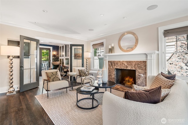 1631 Interlaken Pl E, Seattle, WA 98112 - living room with dark wood finished floors, radiator, ornamental molding, a premium fireplace, and french doors