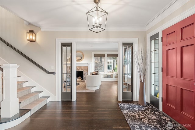 1631 Interlaken Pl E, Seattle, WA 98112 - foyer entrance featuring dark wood-style flooring, stairs, a chandelier, ornamental molding, and a fireplace