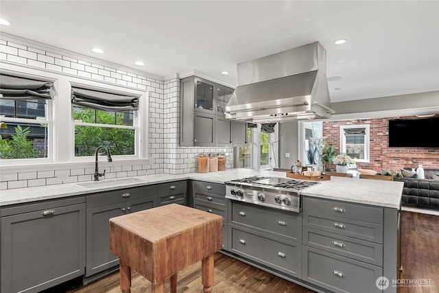 1631 Interlaken Pl E, Seattle, WA 98112 - kitchen featuring gray cabinetry, stainless steel gas stovetop, island range hood, a peninsula, and plenty of natural light
