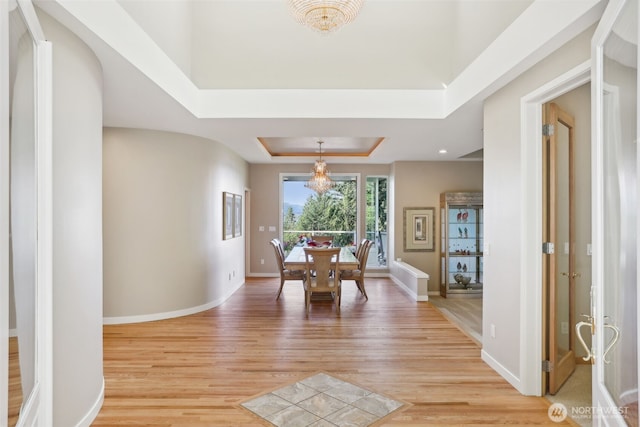 1706 205th Pl NE, Sammamish, WA 98074 - dining room featuring a tray ceiling and light wood-style floors