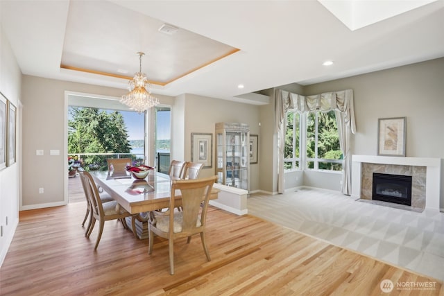 1706 205th Pl NE, Sammamish, WA 98074 - dining room with a premium fireplace, light wood finished floors, a chandelier, recessed lighting, and a tray ceiling