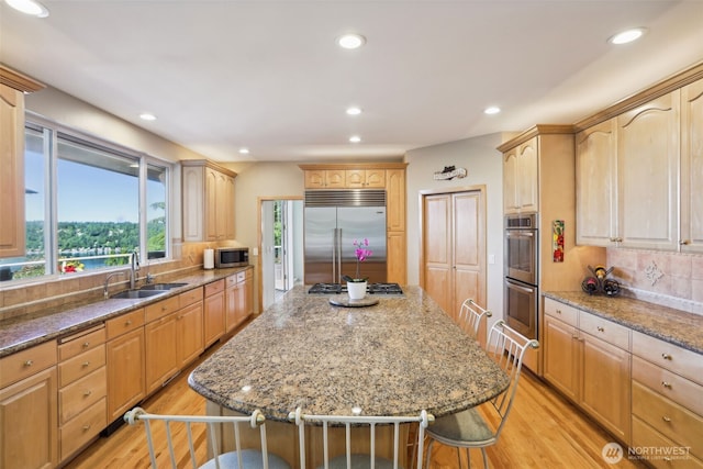 1706 205th Pl NE, Sammamish, WA 98074 - kitchen with appliances with stainless steel finishes, a center island, light wood-style floors, light brown cabinets, and recessed lighting