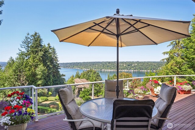 1706 205th Pl NE, Sammamish, WA 98074 - wooden deck featuring a water view, outdoor dining space, and a wooded view