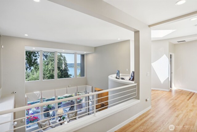 1706 205th Pl NE, Sammamish, WA 98074 - corridor with wood finished floors, recessed lighting, a water view, and a skylight