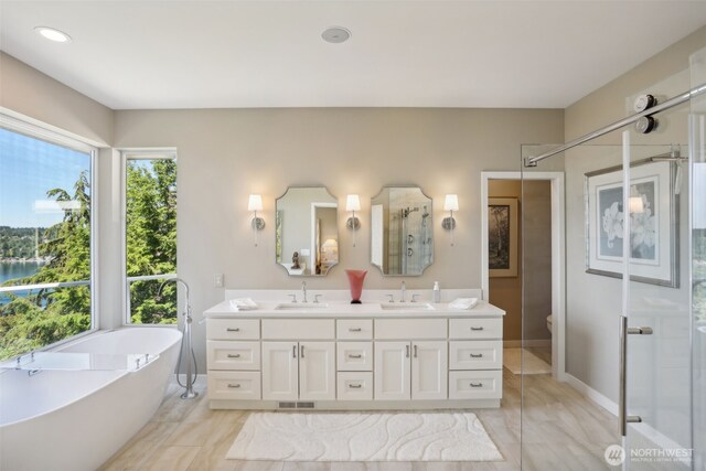 1706 205th Pl NE, Sammamish, WA 98074 - bathroom with double vanity, a freestanding tub, and a stall shower