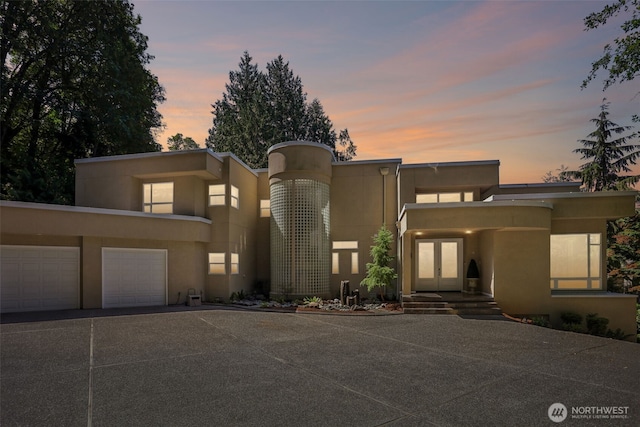 1706 205th Pl NE, Sammamish, WA 98074 - view of front of house featuring french doors, concrete driveway, stucco siding, and an attached garage