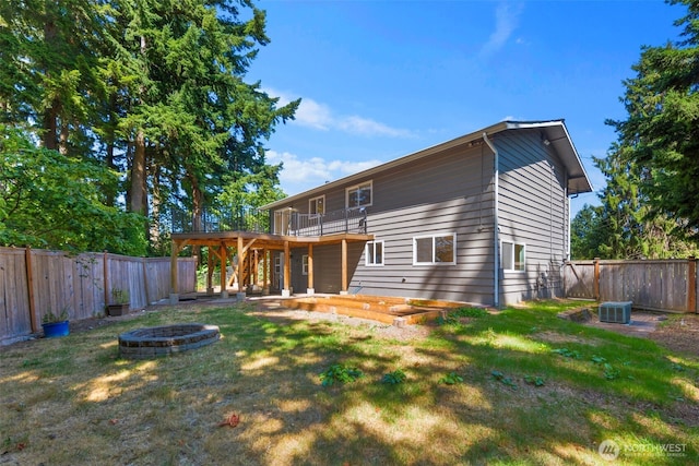 20101 95th Pl NE, Bothell, WA 98011 - rear view of house with a fire pit, a fenced backyard, and a wooden deck