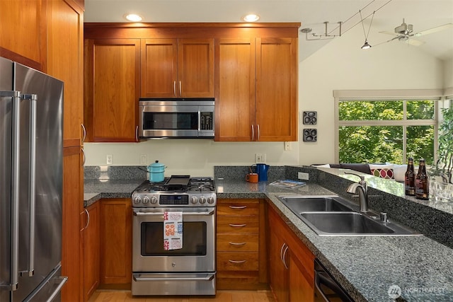 2035 Eastlake Ave E Unit 301, Seattle, WA 98102 - kitchen featuring appliances with stainless steel finishes, brown cabinets, ceiling fan, recessed lighting, and vaulted ceiling
