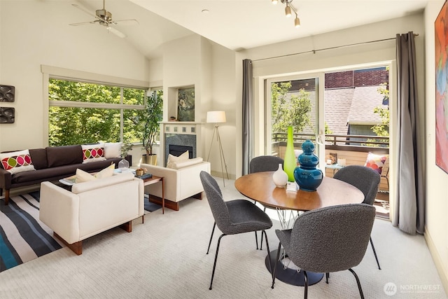 2035 Eastlake Ave E Unit 301, Seattle, WA 98102 - dining room featuring light carpet, a premium fireplace, lofted ceiling, and a ceiling fan