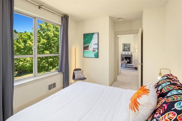 2035 Eastlake Ave E Unit 301, Seattle, WA 98102 - bedroom featuring multiple windows, carpet flooring, and a lit fireplace