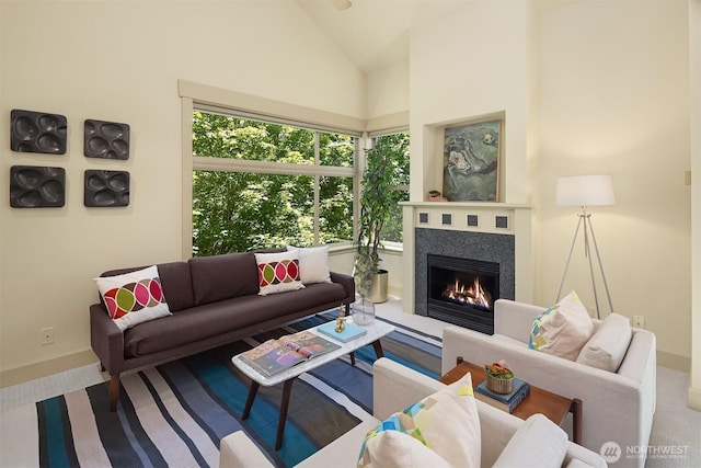 2035 Eastlake Ave E Unit 301, Seattle, WA 98102 - living area featuring a warm lit fireplace, carpet, and high vaulted ceiling