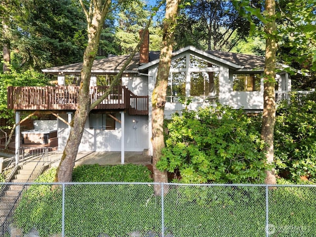 3216 142nd Pl NE, Bellevue, WA 98007 - rear view of property with a wooden deck, a fenced backyard, a chimney, stairway, and a shingled roof