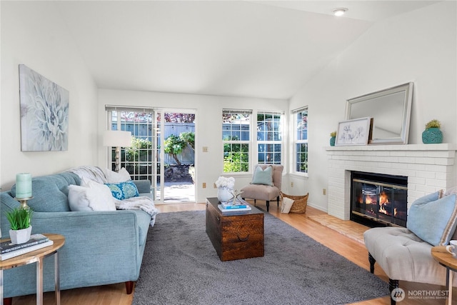 6020 N Highlands Pkwy Unit 52B, Tacoma, WA 98406 - living room with lofted ceiling, plenty of natural light, a fireplace, and wood finished floors