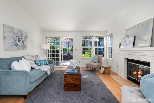6020 N Highlands Pkwy Unit 52B, Tacoma, WA 98406 - living room featuring vaulted ceiling, wood finished floors, and a brick fireplace