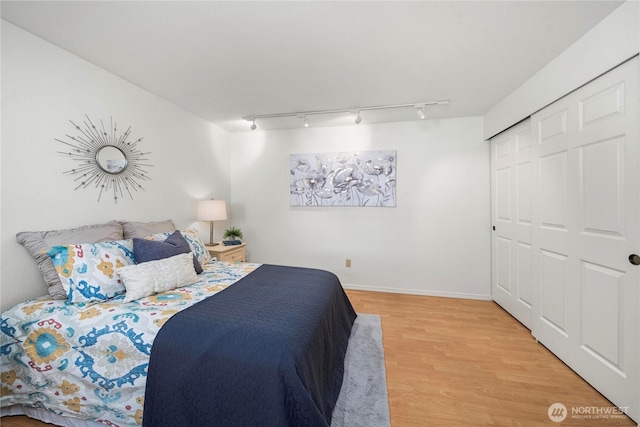 6020 N Highlands Pkwy Unit 52B, Tacoma, WA 98406 - bedroom with rail lighting, light wood-style floors, and a closet