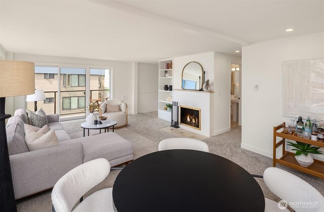 2301 Fairview Ave E Unit 404, Seattle, WA 98102 - living area with light colored carpet, a glass covered fireplace, and recessed lighting