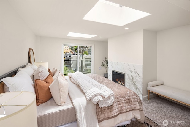 2301 Fairview Ave E Unit 404, Seattle, WA 98102 - bedroom featuring a skylight, carpet flooring, a fireplace, and recessed lighting