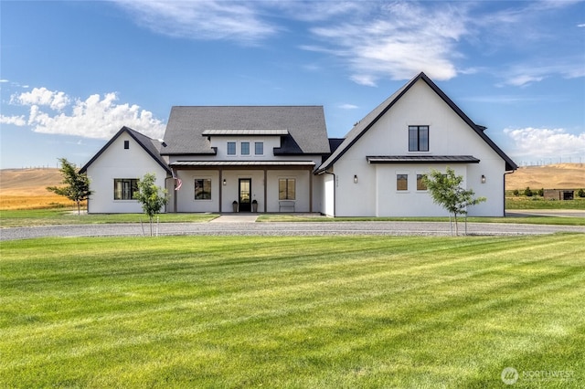2617 Byrnes Rd, Touchet, WA 99360 - rear view of house featuring a standing seam roof, a metal roof, a lawn, and stucco siding