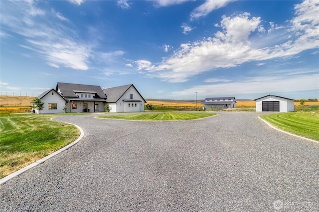 2617 Byrnes Rd, Touchet, WA 99360 - view of front facade with driveway, a front lawn, an outbuilding, and a detached garage