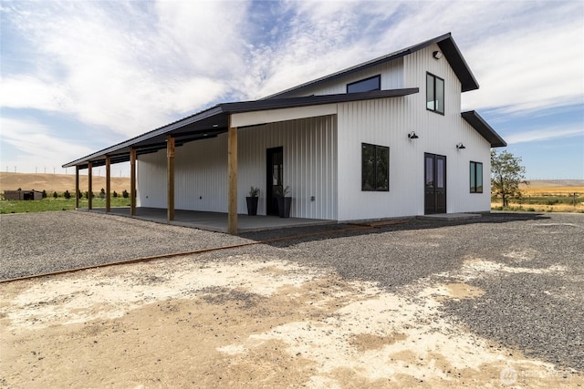 2617 Byrnes Rd, Touchet, WA 99360 - back of house featuring an attached carport, gravel driveway, and a patio
