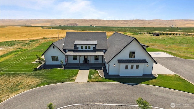 2617 Byrnes Rd, Touchet, WA 99360 - modern inspired farmhouse featuring a rural view, covered porch, a standing seam roof, a metal roof, and stucco siding