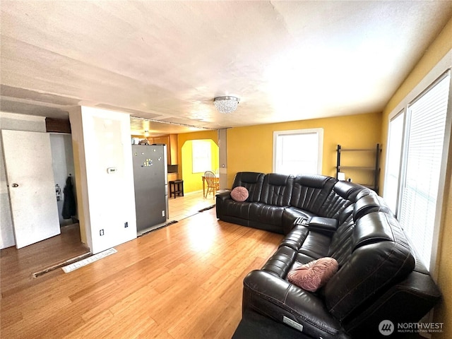 10204 19th Ave SW, Seattle, WA 98146 - living room featuring arched walkways and light wood-style floors