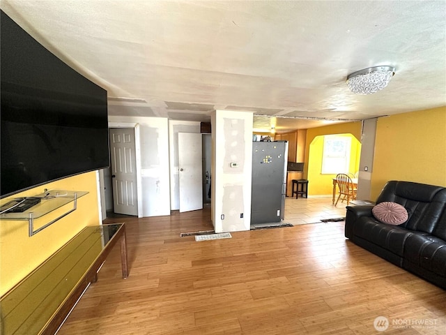 10204 19th Ave SW, Seattle, WA 98146 - living area with arched walkways and light wood finished floors