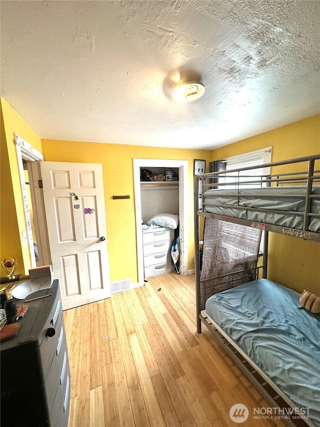 10204 19th Ave SW, Seattle, WA 98146 - bedroom with a textured ceiling, wood-type flooring, and a closet
