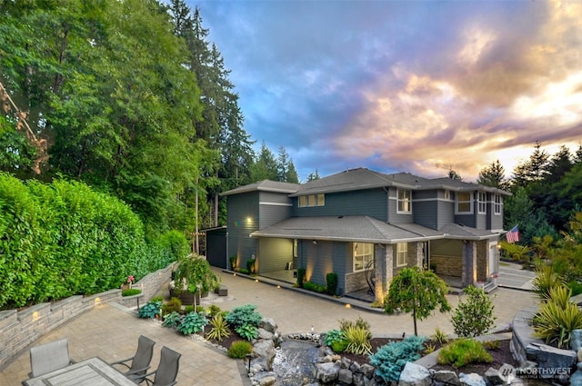 5708 197th Pl SE, Bothell, WA 98012 - back of house at dusk with a patio area