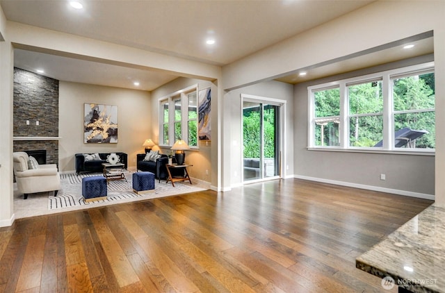 5708 197th Pl SE, Bothell, WA 98012 - living room featuring wood-type flooring, a stone fireplace, plenty of natural light, and recessed lighting