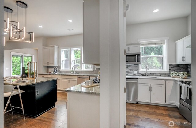 5708 197th Pl SE, Bothell, WA 98012 - kitchen with appliances with stainless steel finishes, healthy amount of natural light, decorative backsplash, and recessed lighting
