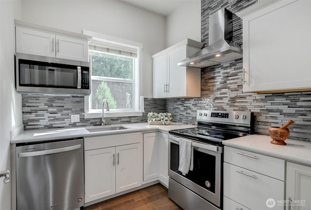5708 197th Pl SE, Bothell, WA 98012 - kitchen with appliances with stainless steel finishes, wall chimney range hood, white cabinetry, and decorative backsplash