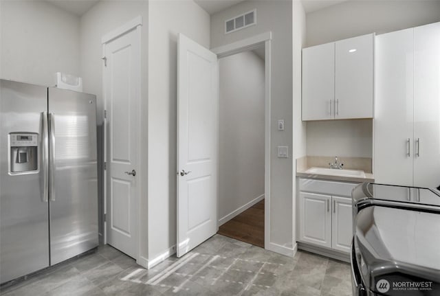 5708 197th Pl SE, Bothell, WA 98012 - kitchen featuring stainless steel refrigerator with ice dispenser, light countertops, and white cabinetry