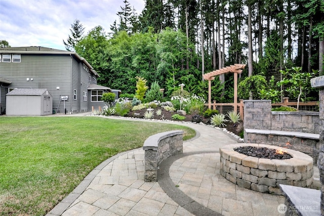 5708 197th Pl SE, Bothell, WA 98012 - view of grassy yard with a fire pit, a patio area, and a storage shed