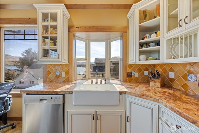 2020 W Woodin Ave, Chelan, WA 98816 - kitchen with stainless steel dishwasher, tasteful backsplash, light countertops, and glass insert cabinets