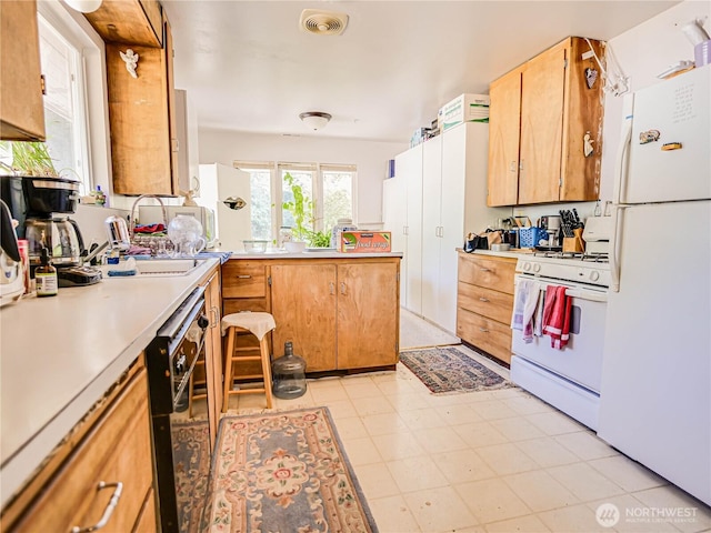 4803 84th St SW, Mukilteo, WA 98275 - kitchen with white appliances, light countertops, and a peninsula