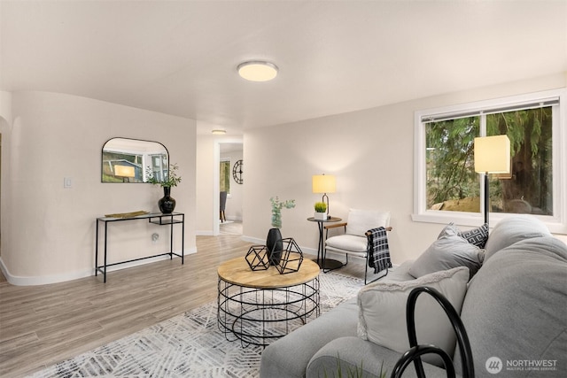 18006 116th Ave SE, Renton, WA 98058 - living room featuring light wood finished floors and arched walkways