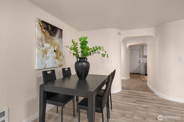 18006 116th Ave SE, Renton, WA 98058 - dining space featuring arched walkways and light wood-style floors