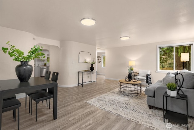 18006 116th Ave SE, Renton, WA 98058 - living room featuring arched walkways and light wood finished floors