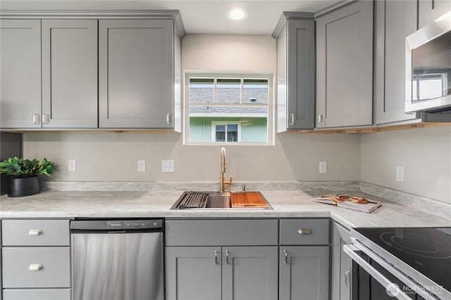 1608 W Market St, Aberdeen, WA 98520 - kitchen with stainless steel appliances, gray cabinetry, and light countertops